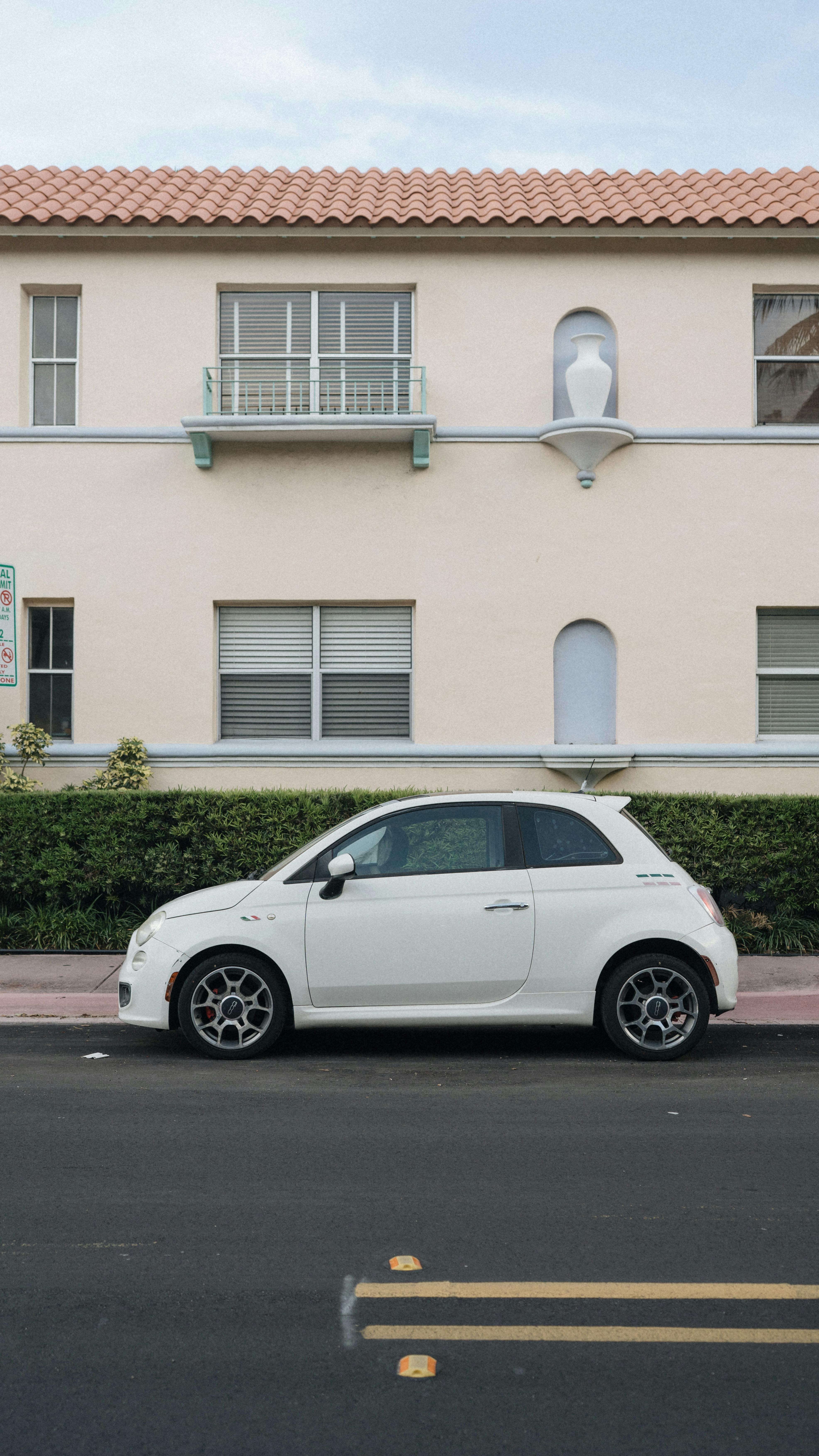 Компактный белый автомобиль, припаркованный на городской улице