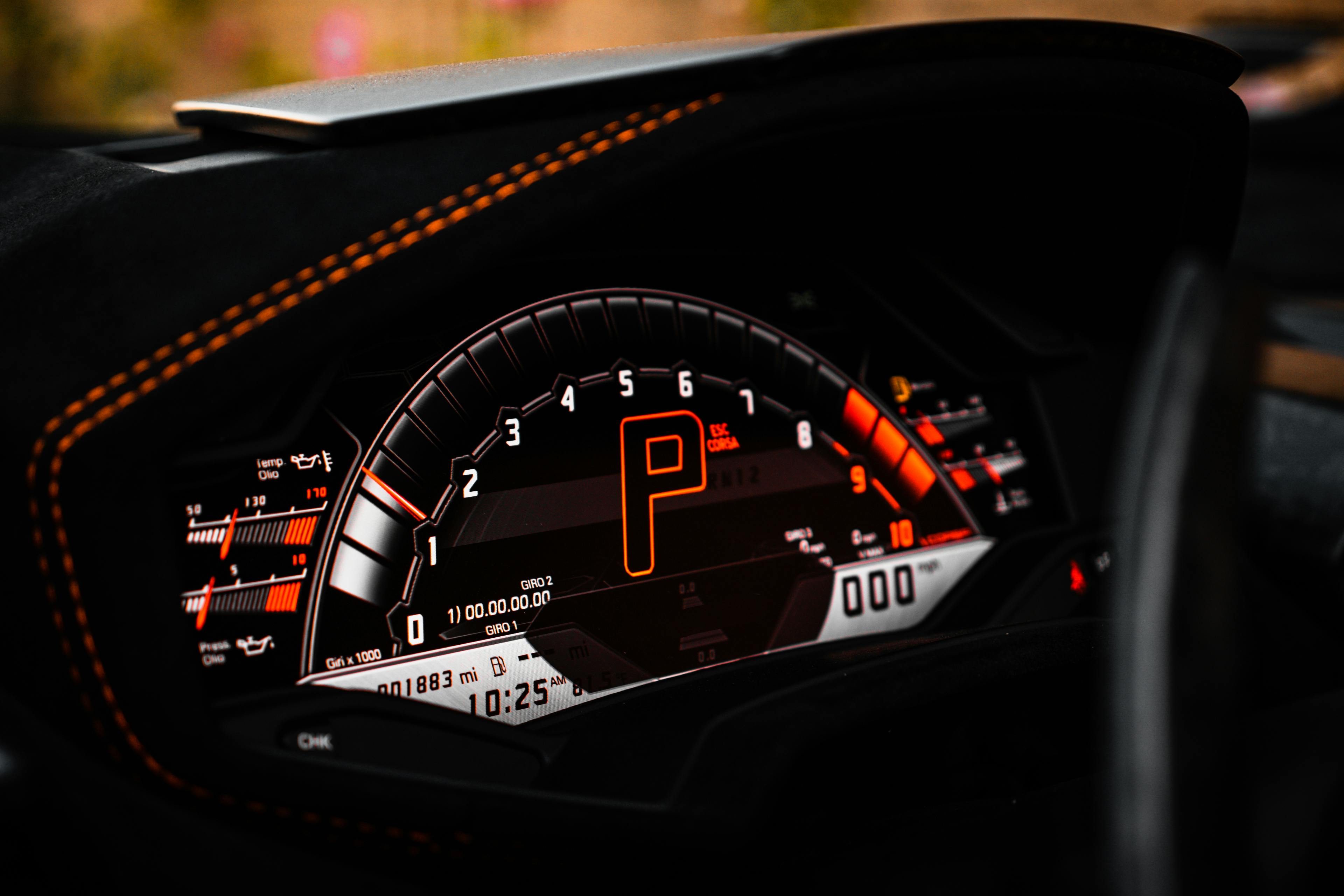 Illuminated car dashboard at night showing speed and RPMs